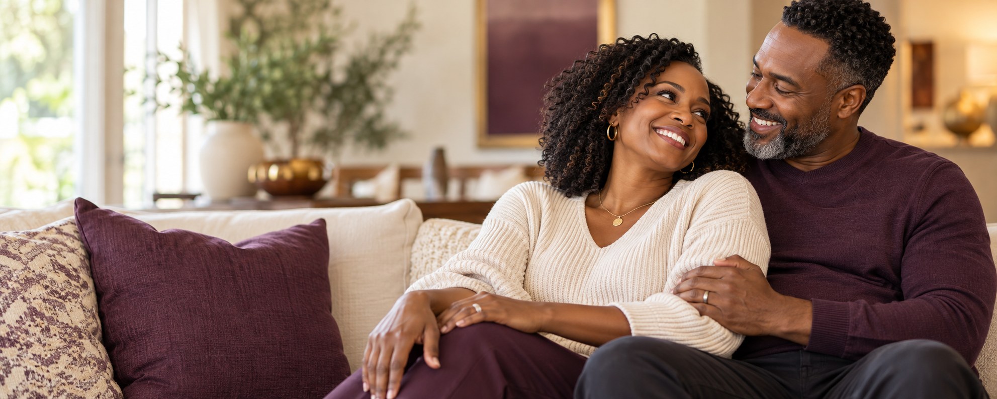 A joyful Black married couple relaxing together at home